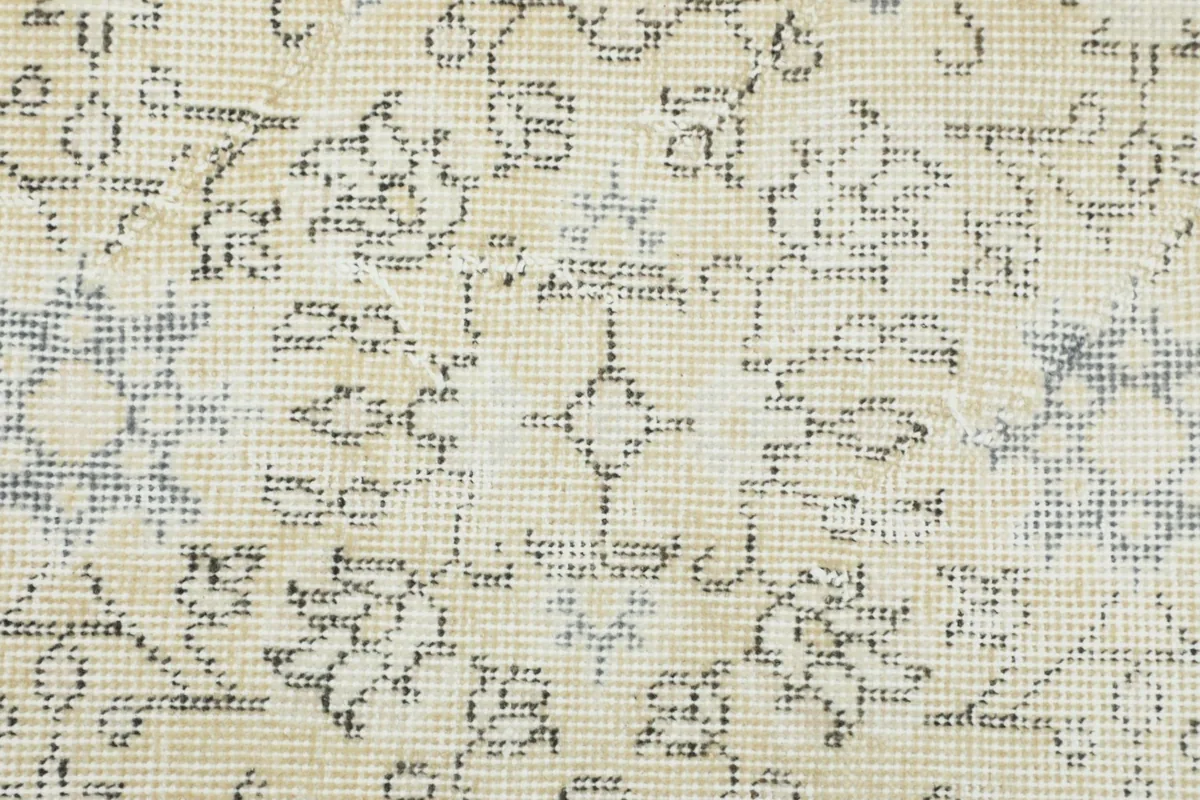 Extreme close-up of the wool pile, showing the texture and faded patterns