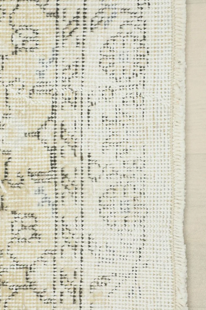 View of the rug's reverse side, showing the hand-knotted cotton foundation