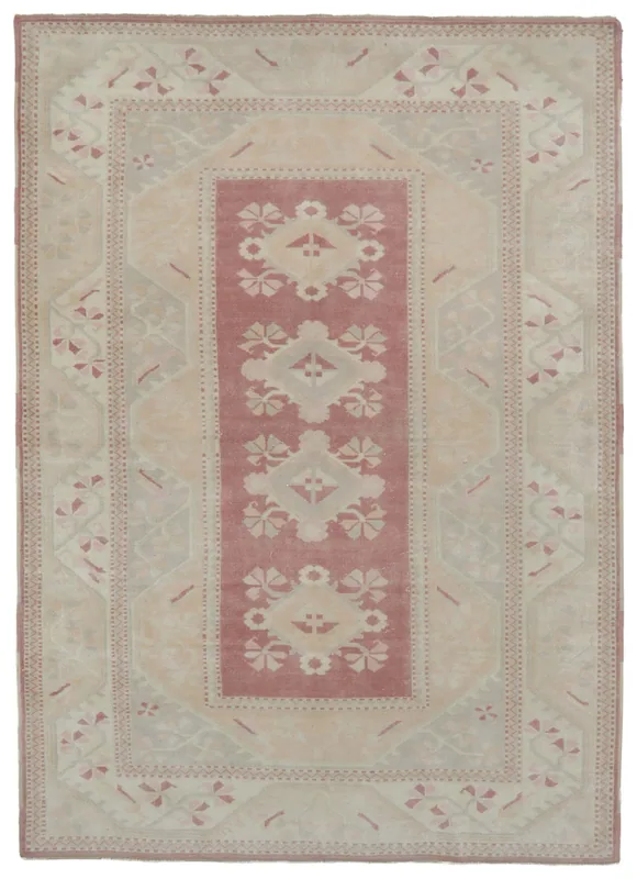 Full overhead view of the rose and beige vintage Anatolian area rug on a white background