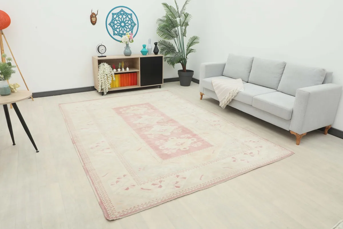 Vintage Anatolian rug displayed in a modern living room setting with a light gray sofa