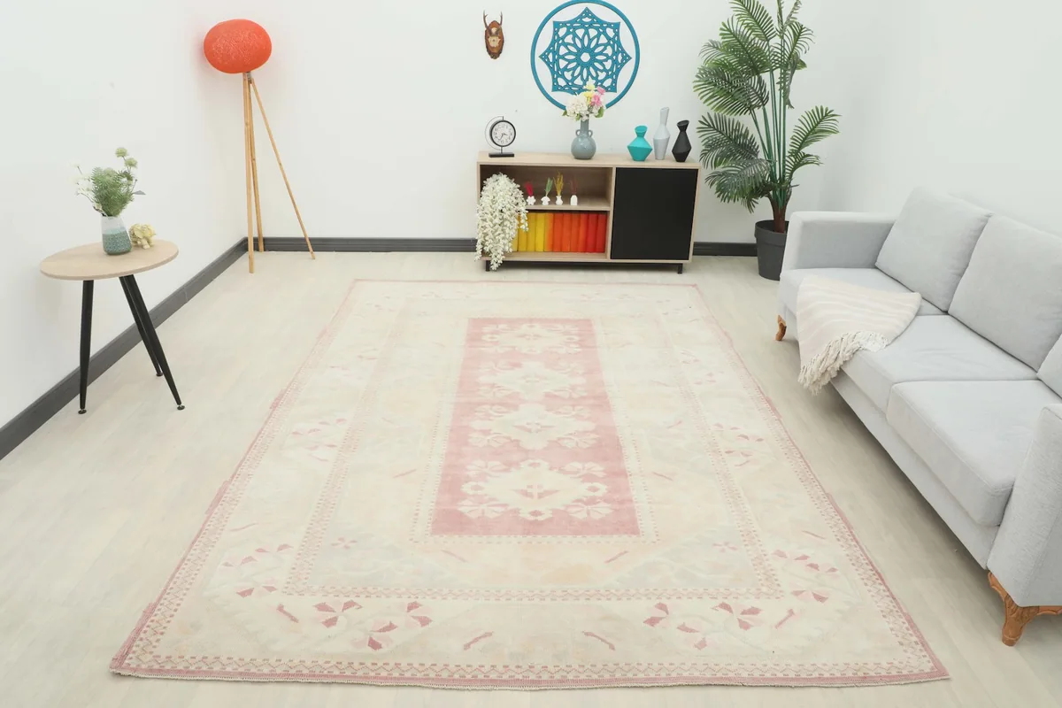 Full room view of the rose and beige area rug, providing context for its size and aesthetic