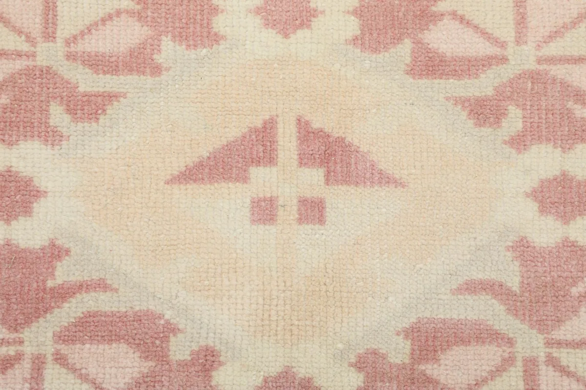 Close-up of a specific geometric motif within the rug's central design, showing texture