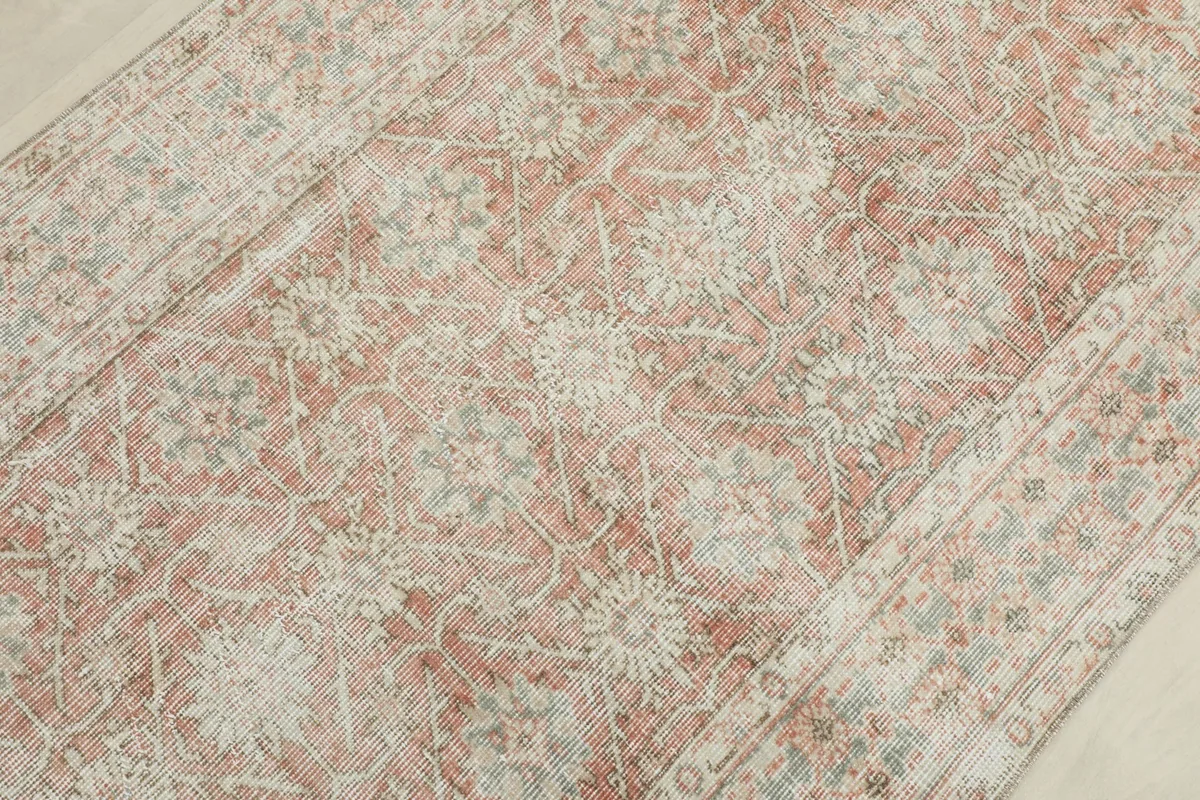 Detailed view of the rug's surface, showing the hand-knotted texture and soft color variations.