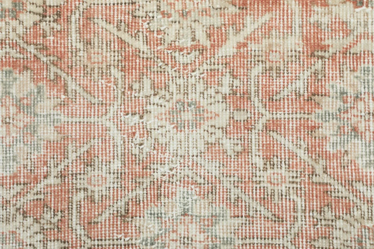 Extreme close-up of the rug's low wool pile, revealing the intricate knotting and color blend.