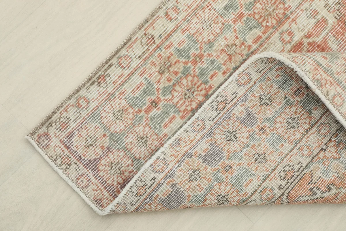 Corner of the runner folded back, showing the backside of the hand-knotted wool on cotton foundation.