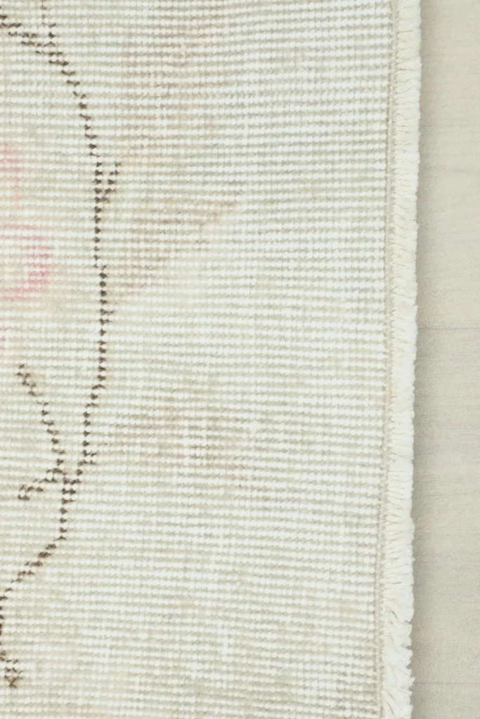 View of the back of the rug, showing the cotton foundation and knotting