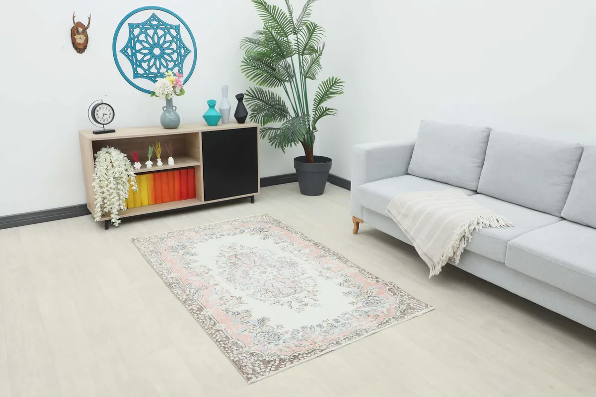 Rose Ivory Floral Anatolian Rug placed in a modern living room setting with a gray sofa