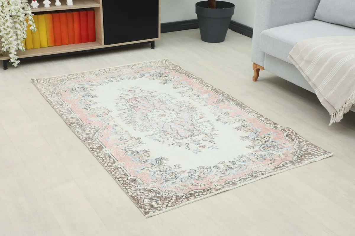 Angle view of the Rose Ivory Floral Anatolian Rug in a room, highlighting its placement
