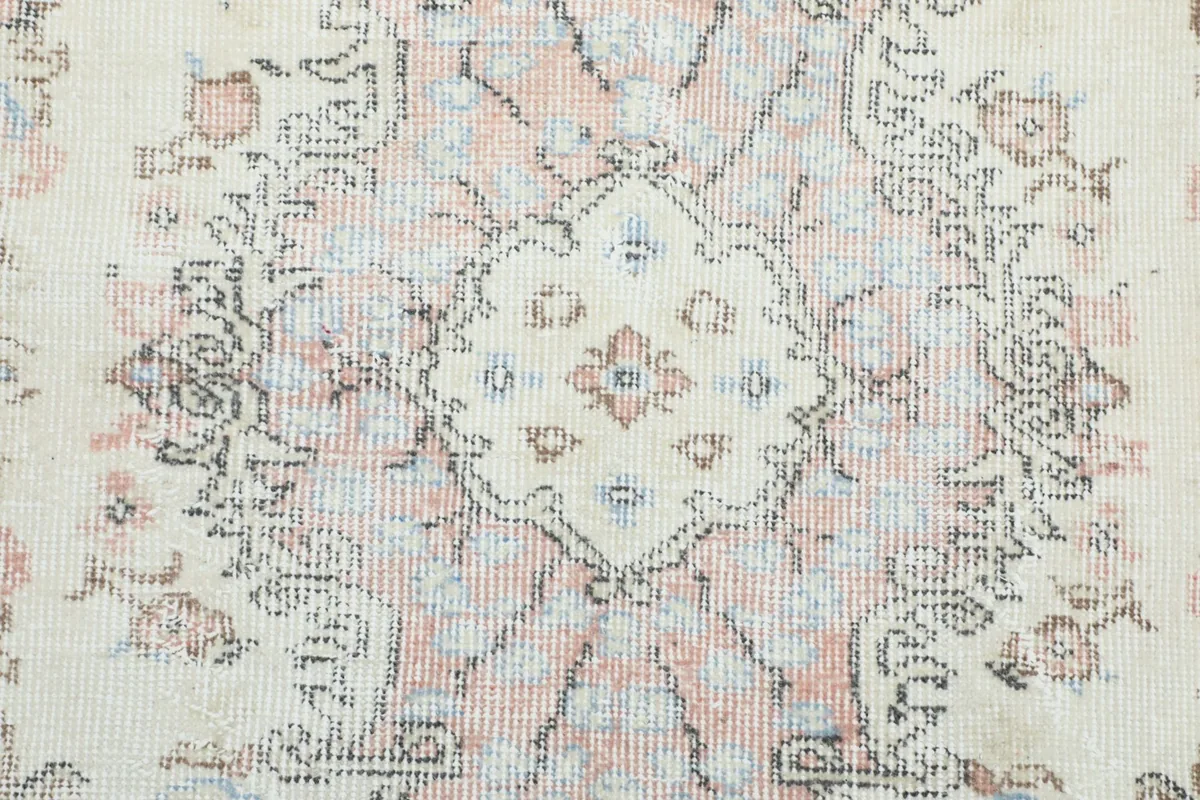 Close-up of the rug's intricate floral and geometric patterns in the center
