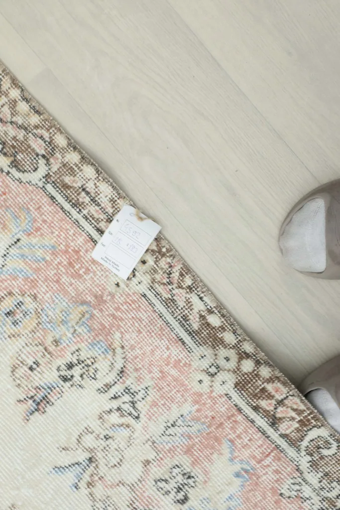 Close-up of the rug's reverse side, revealing the hand-knotted construction and tag