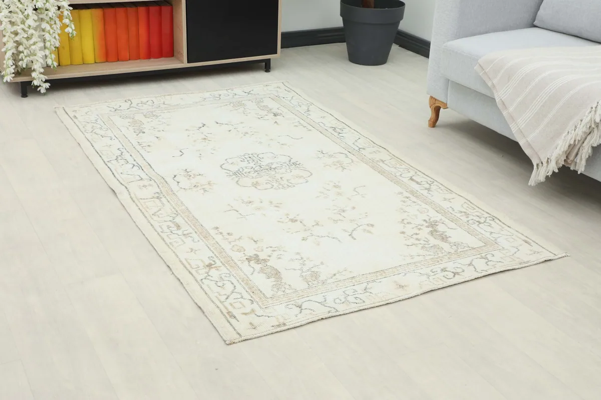 Angle view of the rug in a room, highlighting its placement next to furniture.