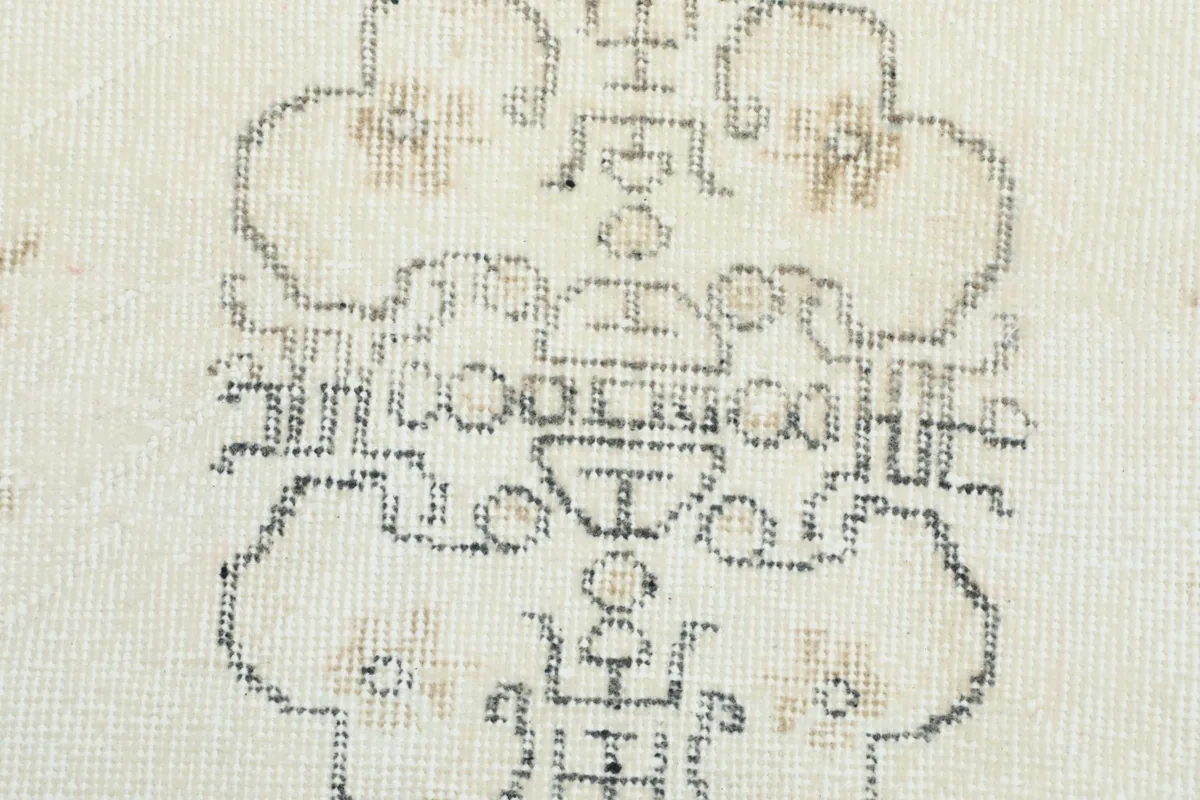 Extreme close-up on the intricate weaving and subtle color variations within the central medallion.