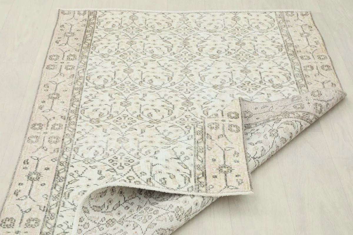 The rug partially folded, showcasing its flexibility and the uniform pattern across the surface