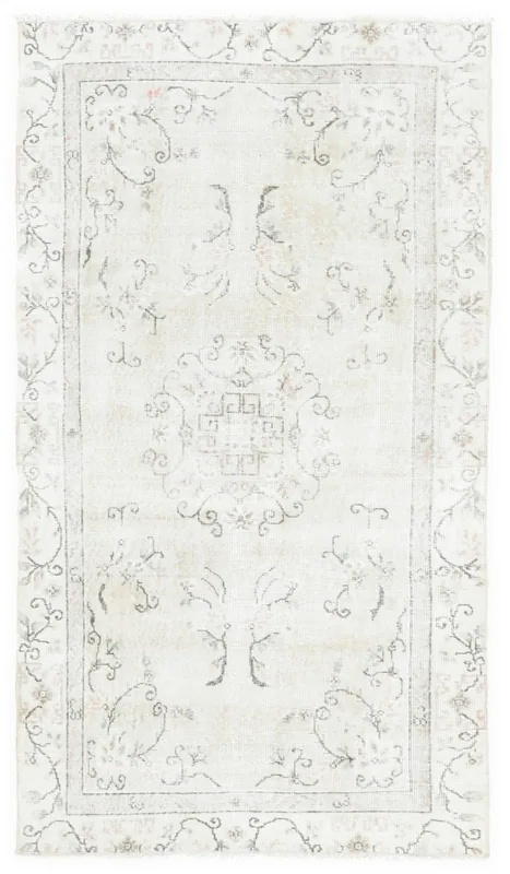 Full overhead view of the beige vintage Anatolian area rug with floral medallion design.