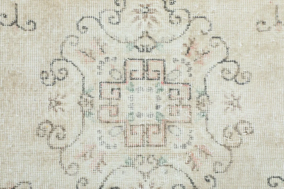 Close-up of the intricate patterns and wool pile texture in the rug's center.