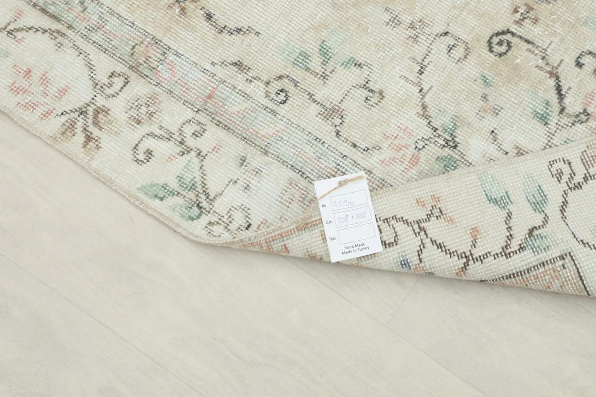 View of the rug's reverse side and label, confirming its origin and material.