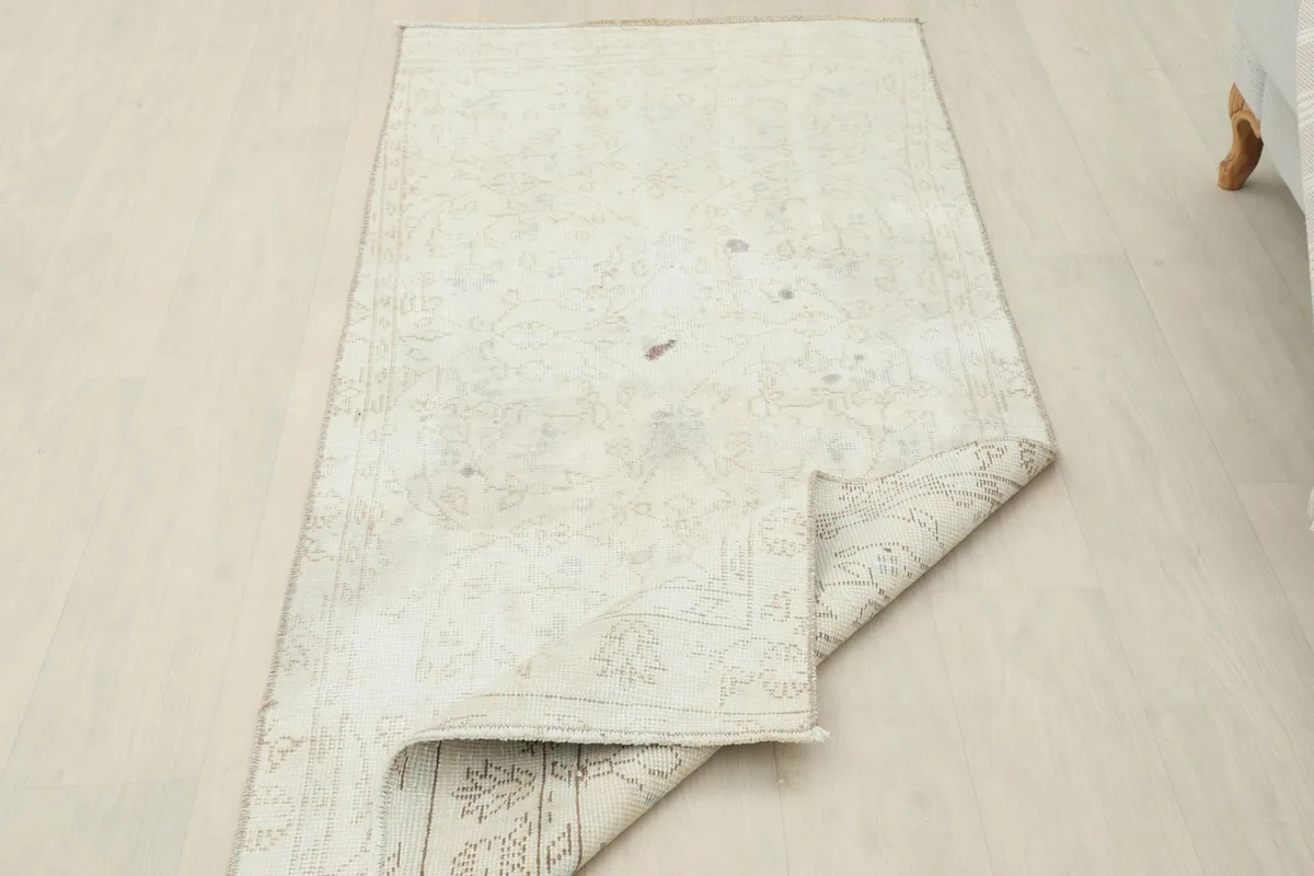 Rug partially folded, showing the flexibility and construction from an angle