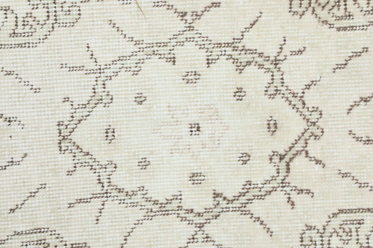 Close-up showing the low pile texture and intricate hand-knotted details of the rug