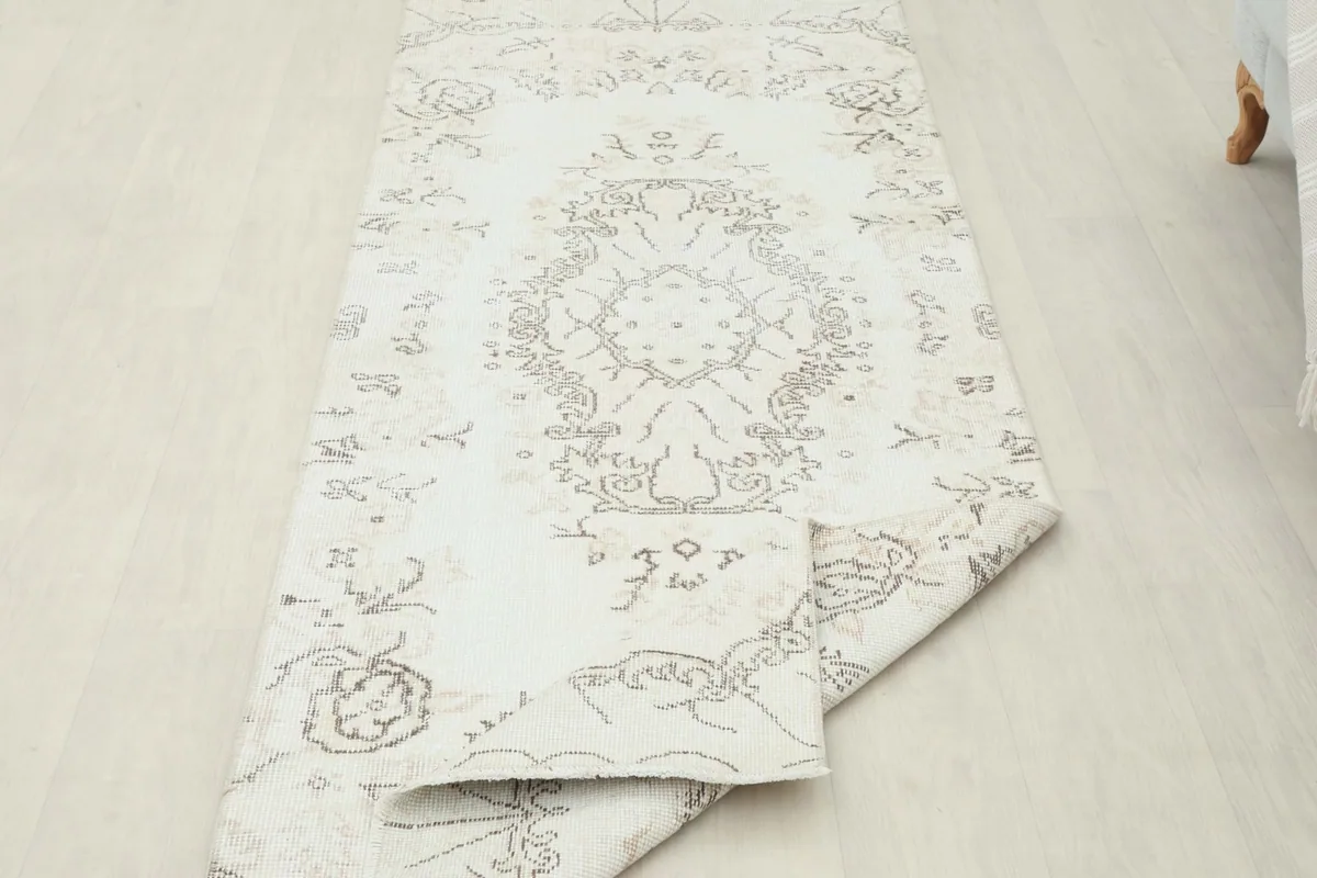 The runner rug partially folded, demonstrating its flexibility and construction
