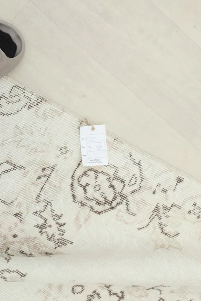Overhead view of the rug with a tag, showing the product label details
