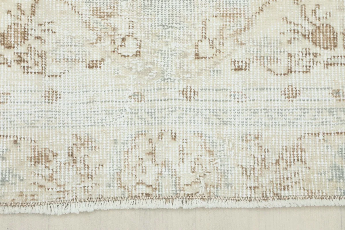 Close-up of the short, natural fringe and the end of the hand-knotted vintage wool rug