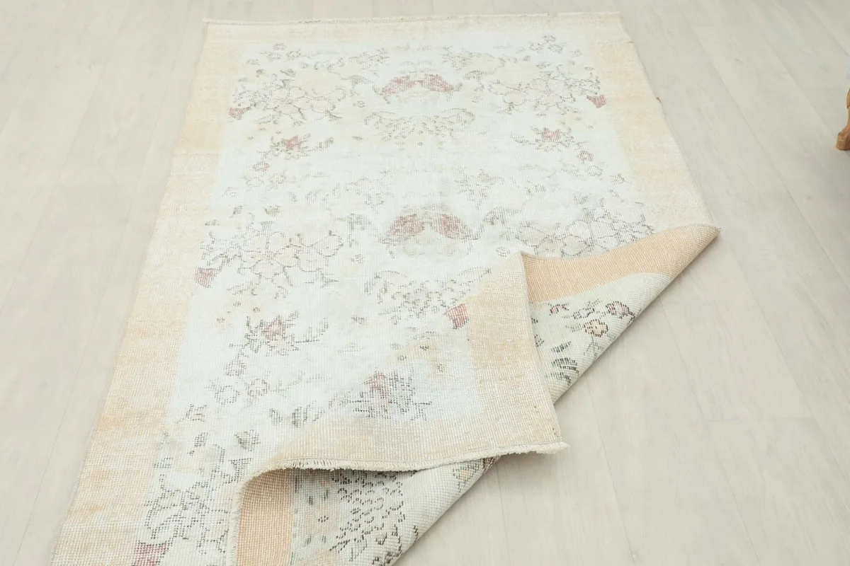 Another view of the rug folded, emphasizing the texture and the vintage character of the piece.