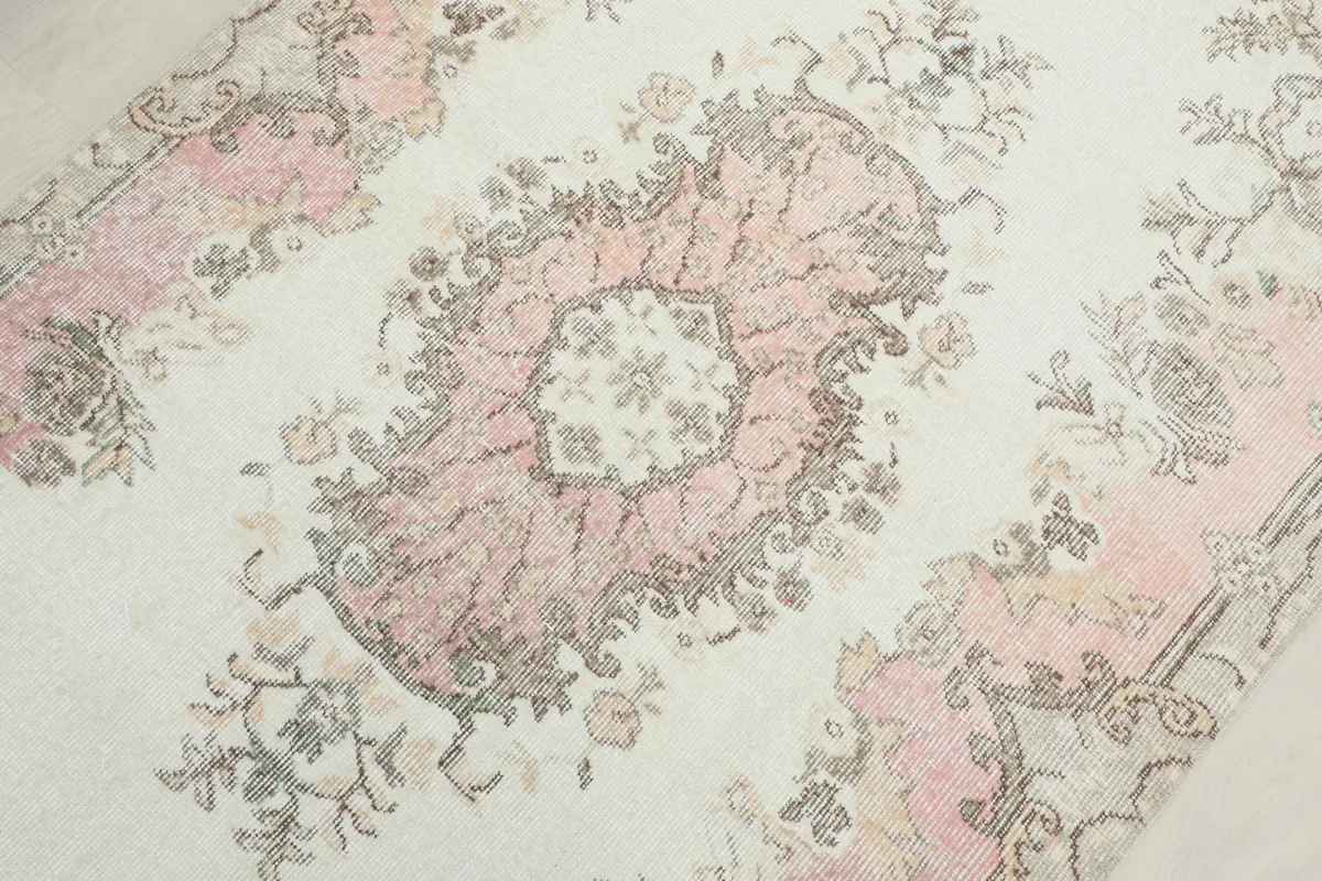 Close-up of the central pink medallion and surrounding floral motifs