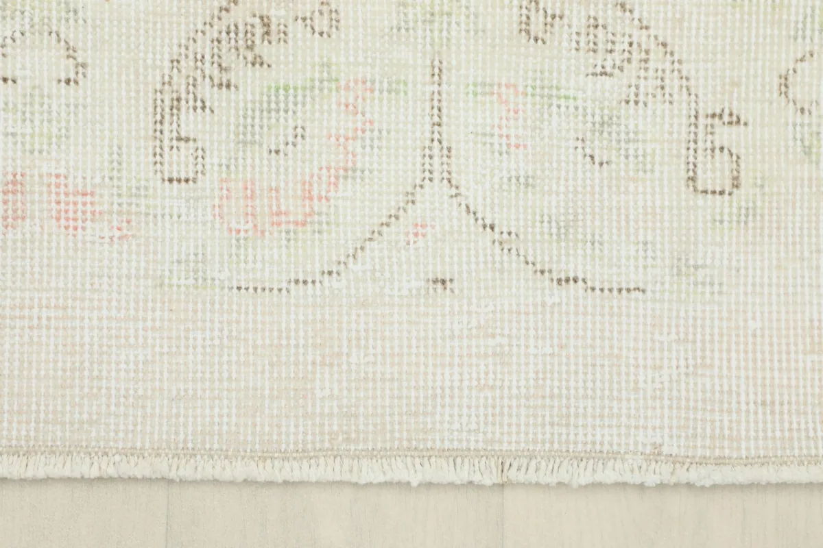 Close-up of the short, natural fringe and the edge of the hand-knotted vintage rug