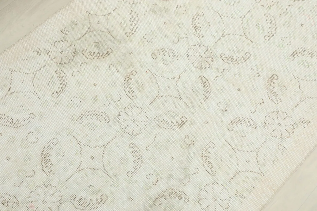 Overhead view showing the repeating floral and geometric motifs across the rug's surface