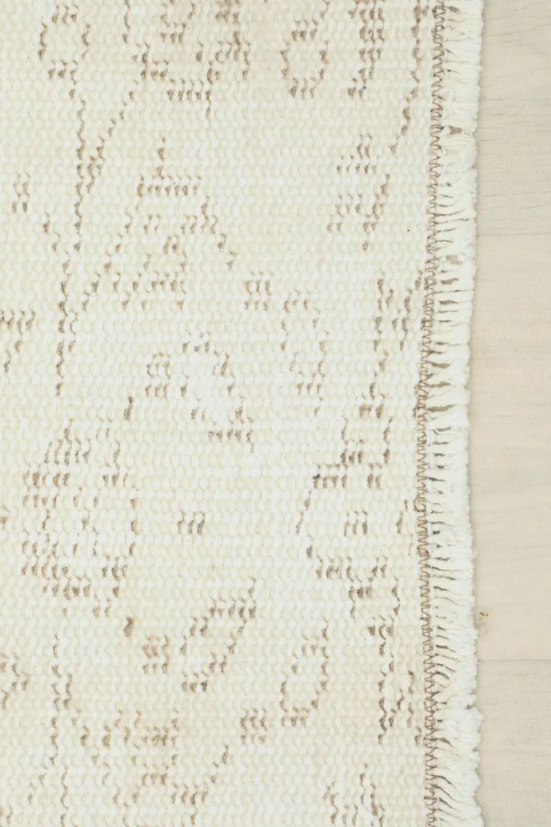 Detail of the Ivory Floral Anatolian Runner's edge and fringe, showcasing the craftsmanship.