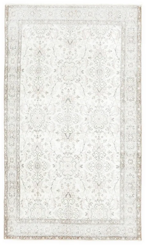 Full top view of the ivory and beige vintage Anatolian area rug on a white background.