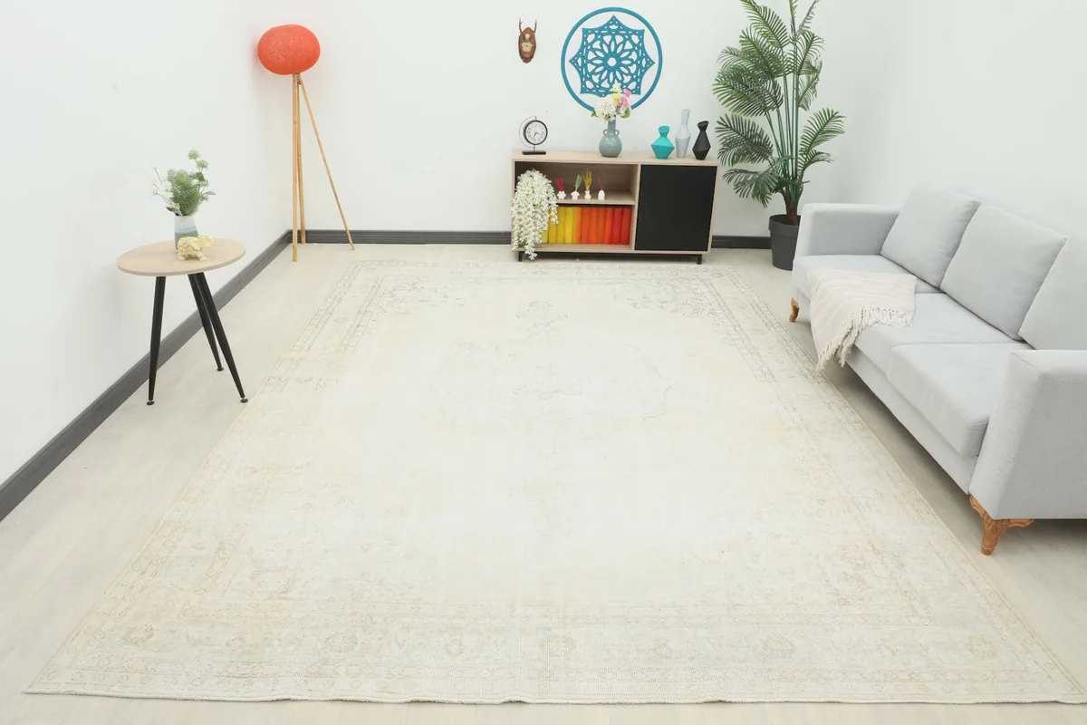 Full room view of the 9x12 ivory vintage rug, showcasing its overall presence and light color palette