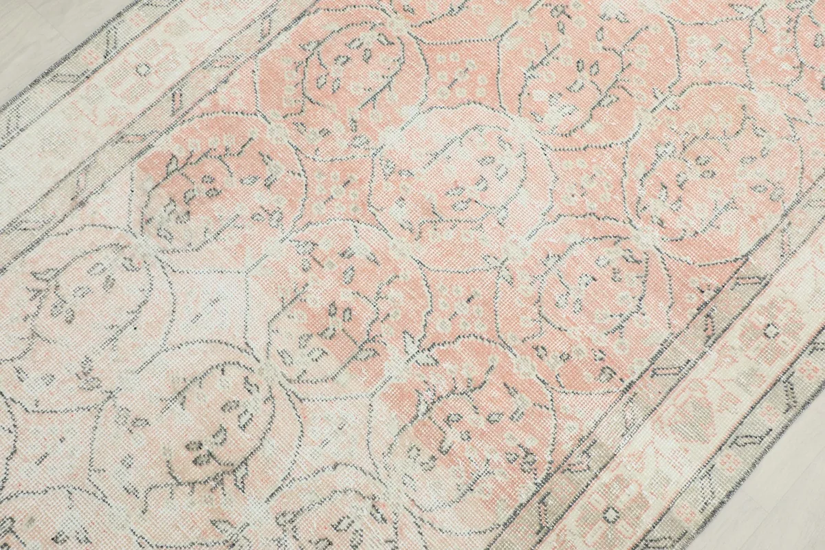 Detailed view of the central geometric motifs and color variations within the rose field