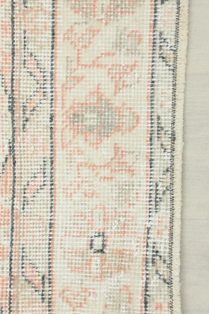 View of the reverse side of the rug, showing the cotton foundation and hand-knotted construction