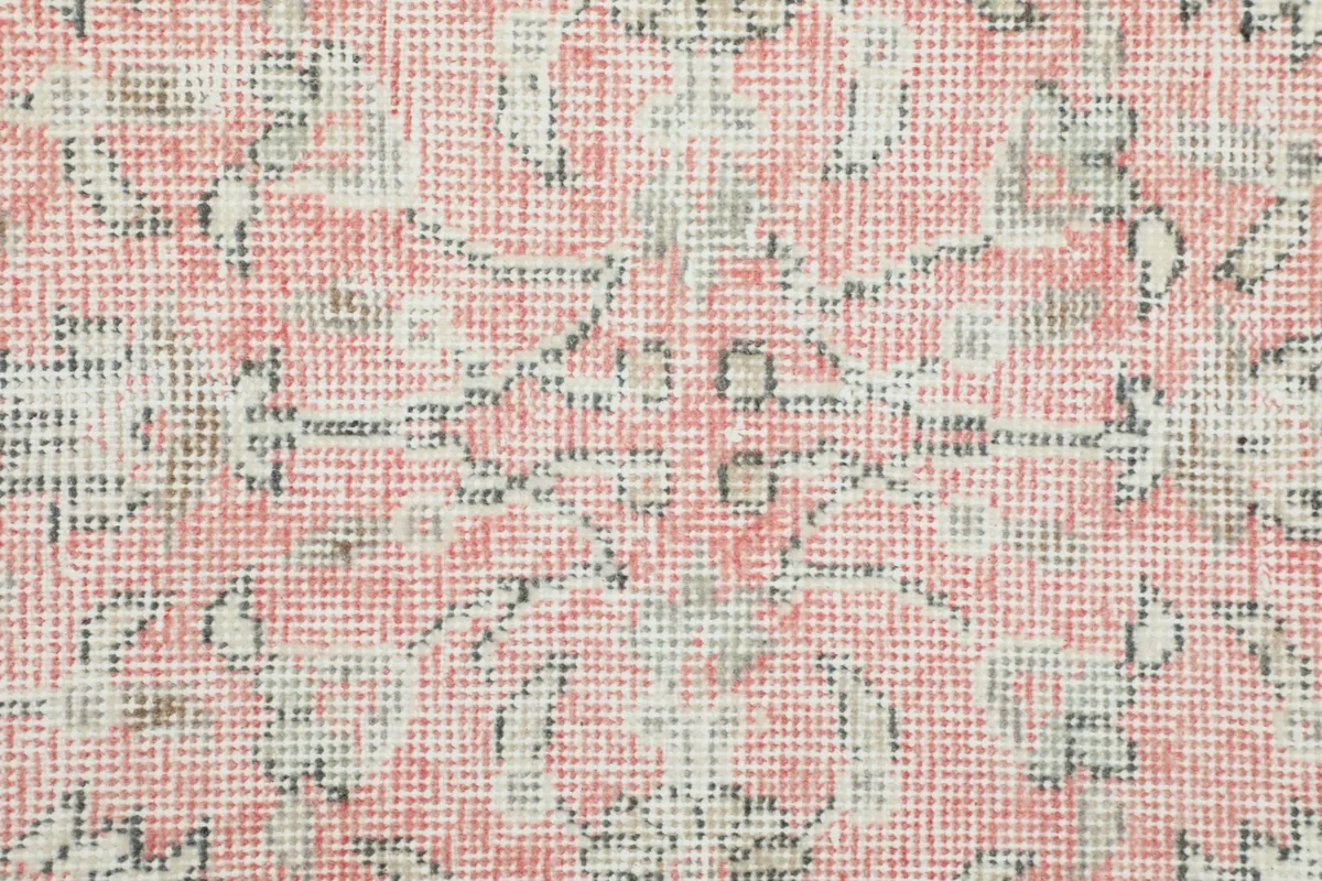 Macro detail view of the hand-knotted pile, showing the texture and intricate floral pattern.