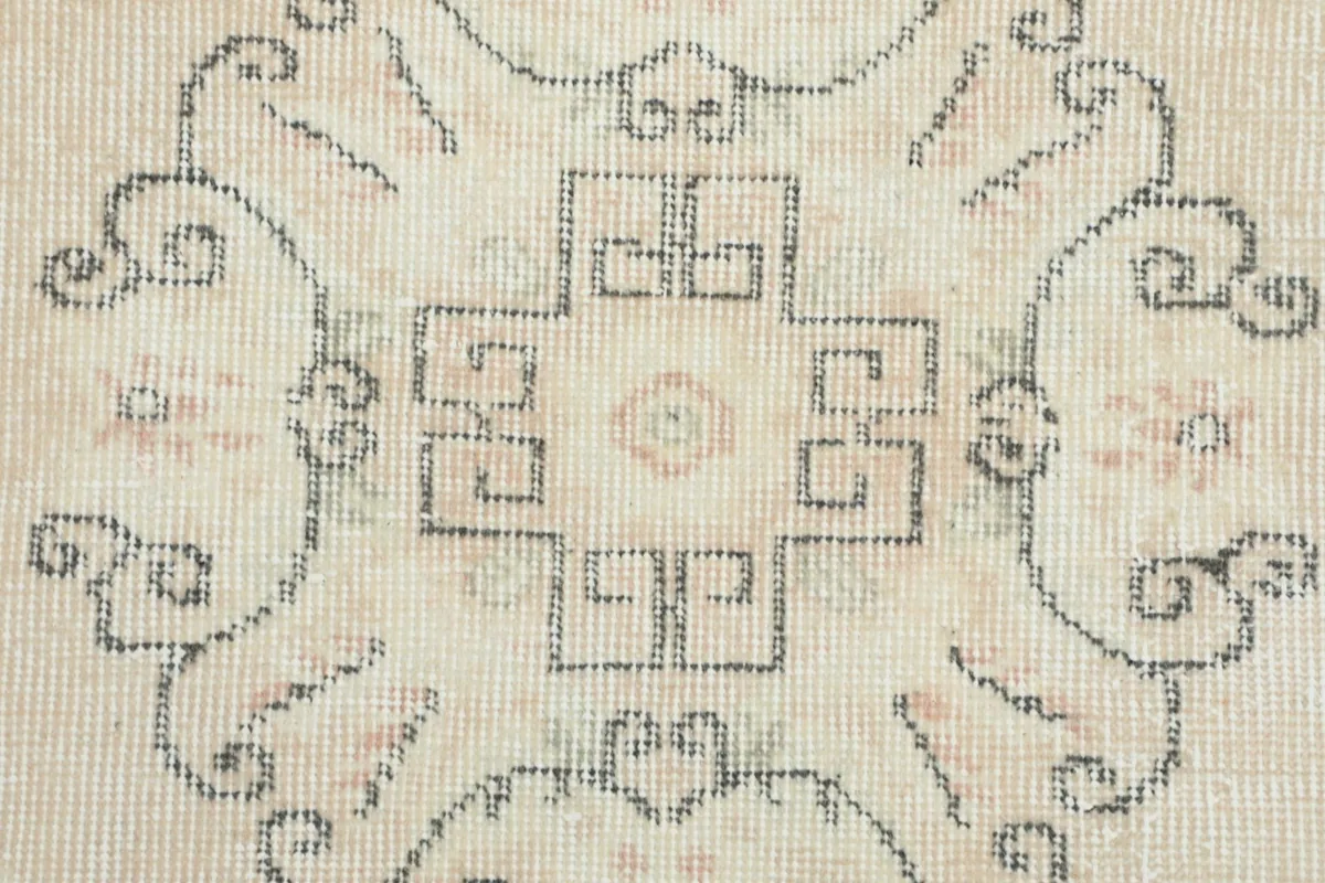 Close-up of the central medallion, revealing the intricate geometric details and subtle color variations.