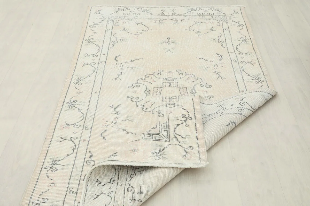 Rug partially folded, demonstrating its flexibility and the overall design from an elevated perspective.