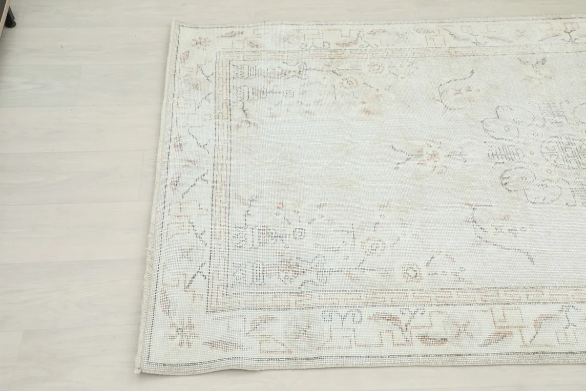 Another close-up detail of the rug's border and field, showing the subtle geometric designs