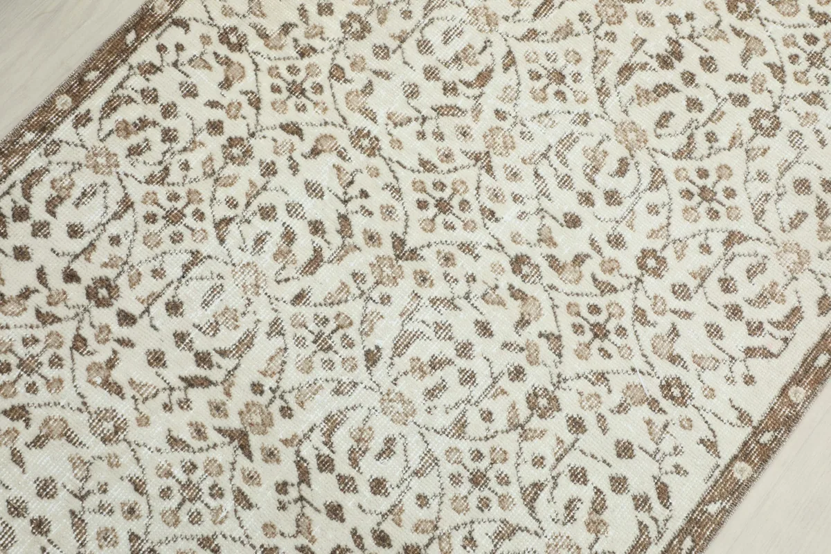 Overhead close-up of the hand-knotted wool pile and subtle color variations