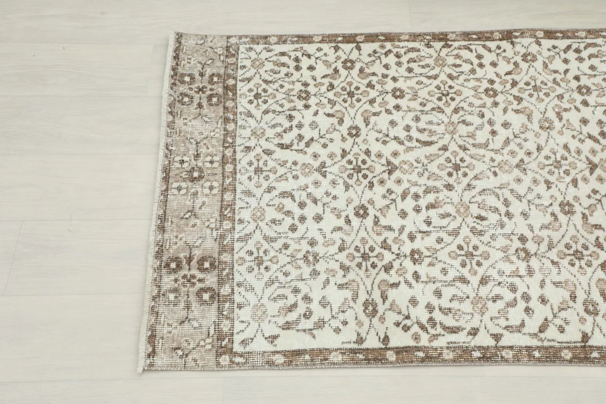Detail showing the intricate border design and corner of the vintage runner