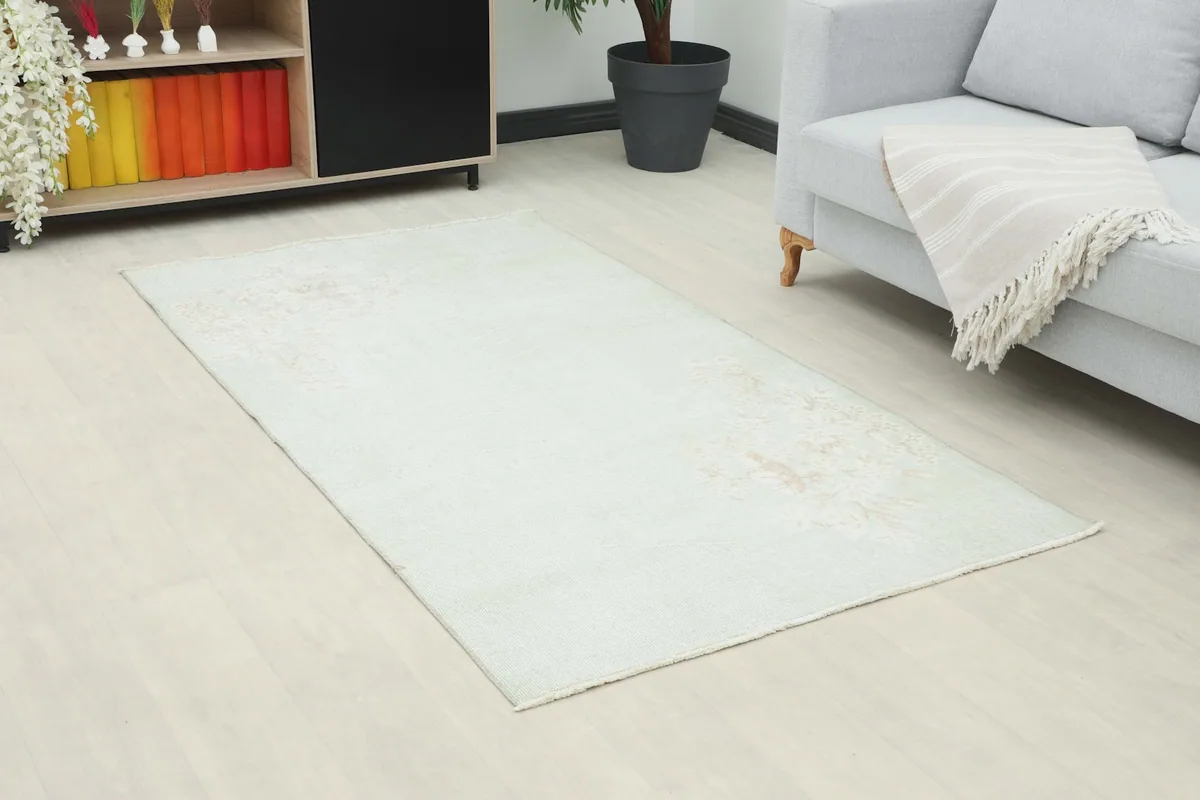 Overhead view of the small area rug in a room, showing its placement on light flooring