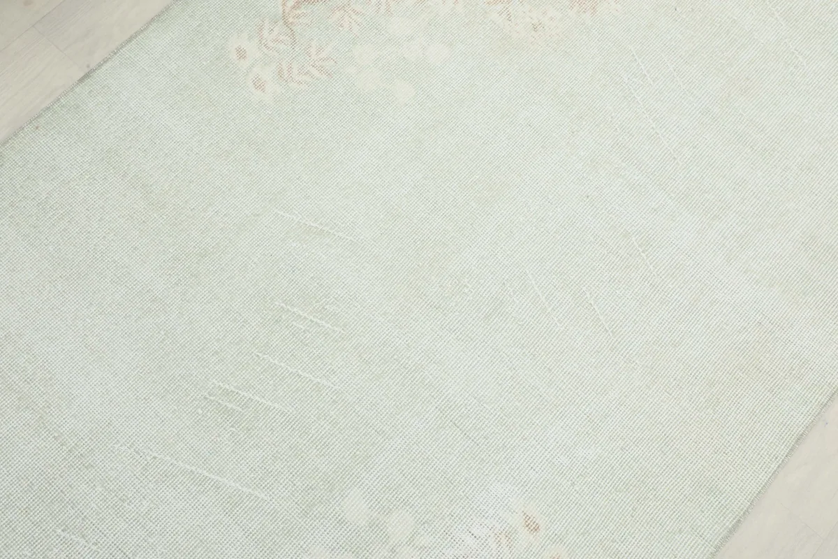 Close-up of the rug's surface, revealing the soft texture and gentle color variations