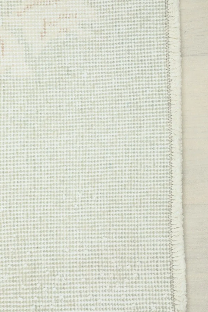 The cotton foundation and reverse side of the hand-knotted vintage rug