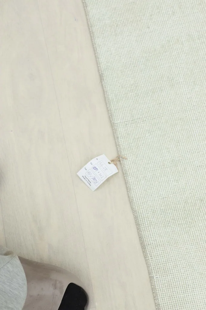 Close-up of the tag attached to the rug's back, indicating details and origin