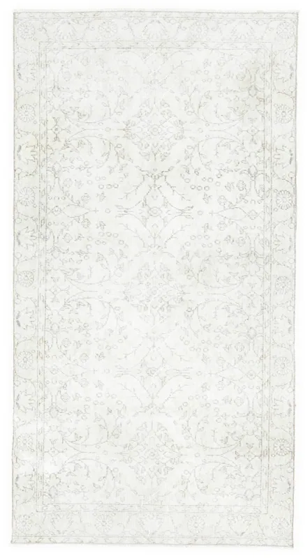 Full top view of a beige vintage Anatolian rug with subtle floral and geometric patterns
