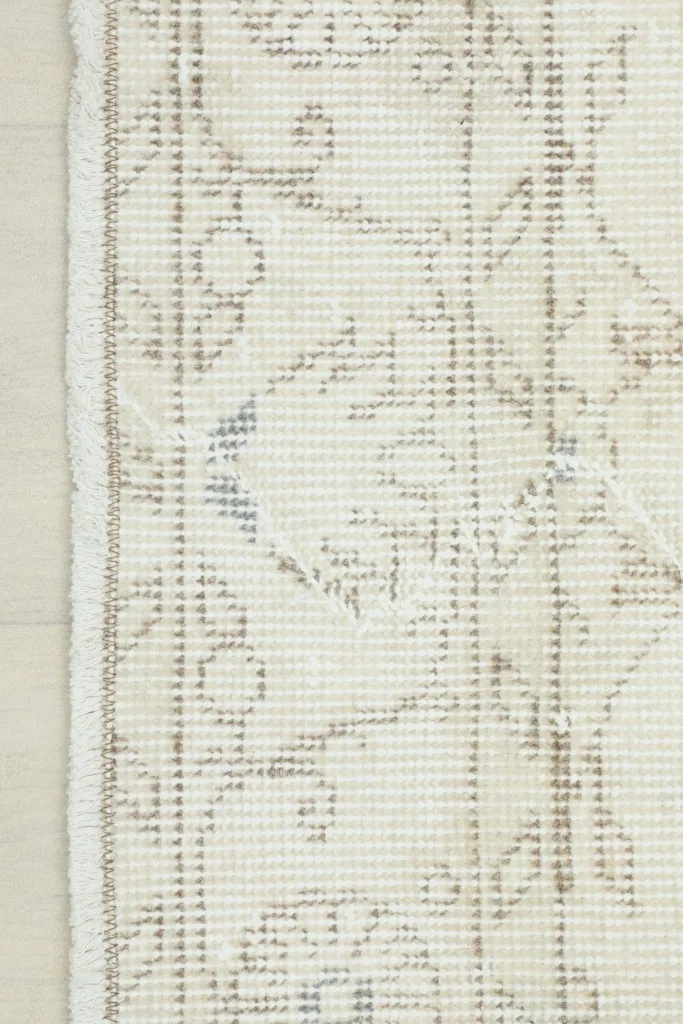 Close-up showing the low pile texture and hand-knotted construction of the rug