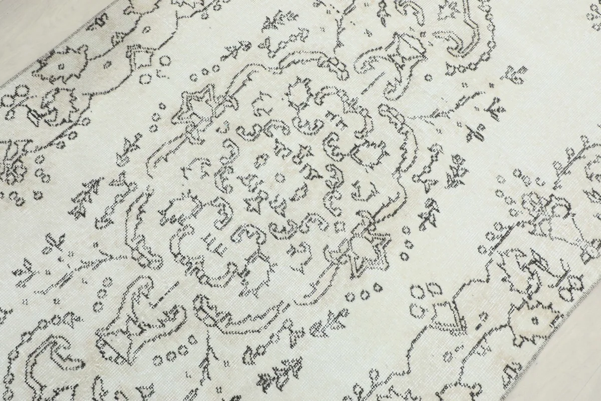 Mid-section detail of the rug, focusing on the central medallion and surrounding floral motifs.
