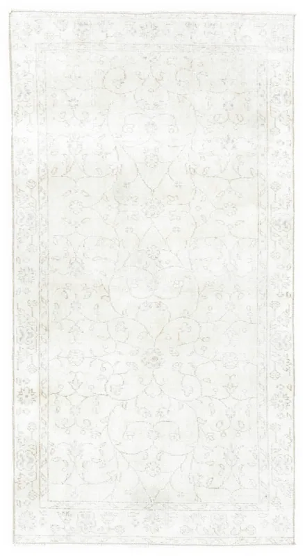 Full overhead view of the ivory vintage Anatolian rug with subtle floral patterns