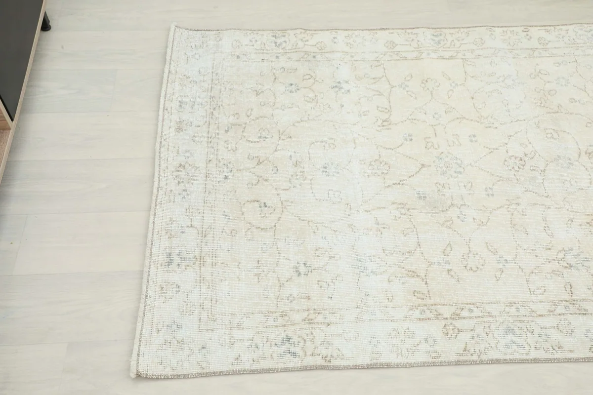 Overhead angled view of the rug's surface, highlighting its faded and distressed texture