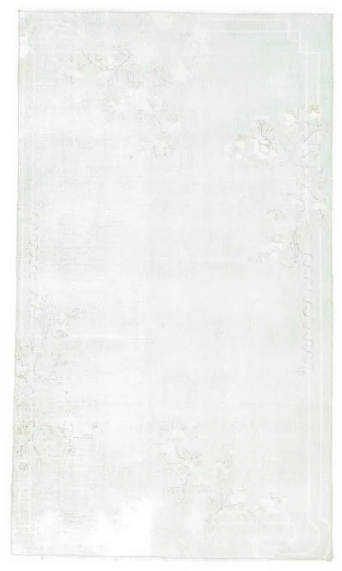 Top view of the 3'8" x 6'4" green and rose floral vintage Anatolian rug on a white background.